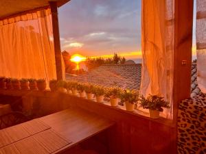 a balcony with potted plants and a sunset in the background at Casa Halcón in Jávea +73 photos