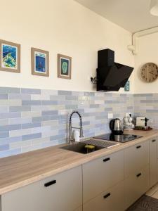 a kitchen with a sink and a counter top at Ora Stay in Papeete