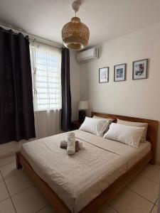 a bedroom with a bed with a stuffed animal on it at Ora Stay in Papeete