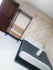 a room with a bed in a room with a refrigerator at Hotel Picasso 70 in Medellín