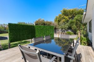 a table and chairs sitting on a wooden deck at Lockwood on Cologne in Martinborough