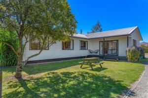 a house with a picnic table in front of it at Lockwood on Cologne in Martinborough