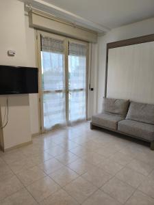 a living room with a couch and a flat screen tv at Casa dei Mazzoni in Crema