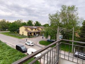 a view of a street with cars parked on the road at Casa dei Mazzoni in Crema