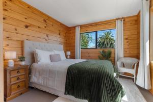 a bedroom with a large bed and a window at Lockwood on Cologne in Martinborough +29 photos
