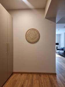 a room with a wall with a plate on the wall at To Be Apartament Palanga in Palanga