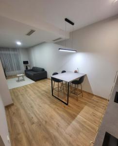 a living room with a table and chairs and a couch at To Be Apartament Palanga in Palanga