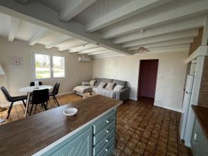 a living room with a couch and a table at T2 charmant dans les Landes in Lesperon