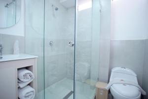 a bathroom with a shower and a toilet at Hotel Cisne in Cuenca