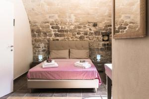A bed or beds in a room at Antico Mercato