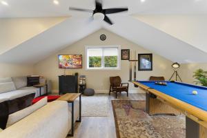 a living room with a ceiling fan and a pool table at Redwood Suite - NOTL Prime Location GETAWAY in Niagara-on-the-Lake