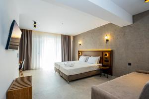 a hotel room with a bed and a couch at Naias in Hanioti +121 photos