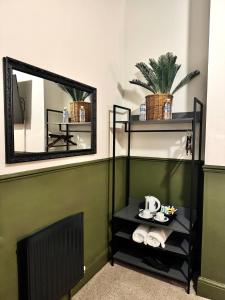 a bathroom with a mirror and a shelf with towels at Piccadilly Central in Manchester