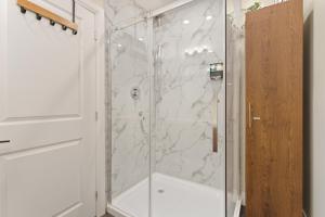 a bathroom with a shower with a glass door at Spruce Suite Historic NOTL - VINEYARD RETREAT in Niagara-on-the-Lake +37 photos