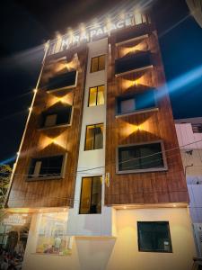 a tall building with lights on it at night at Hotel Hira Palace in Ujjain