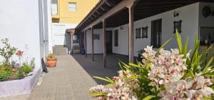 a corridor of a building with flowers and plants at La Barbacoa in Dos Pinos +3 photos