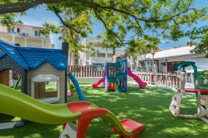 a playground with play equipment in a yard at Naias in Hanioti