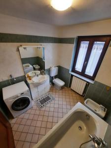 a bathroom with a tub and a sink and a toilet at Casa Vacanza Dal Contadino in Corteno Golgi +39 photos