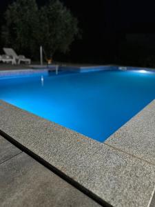 a swimming pool with blue water on top of a building at Holiday Home Slap Koćuša in Ljubuški