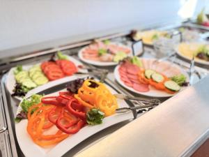 a buffet with many plates of food on a table at The Business Loft in Wolfsburg +113 photos