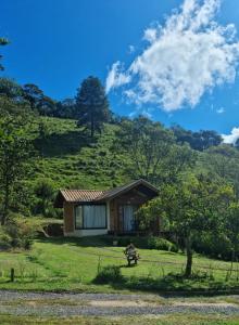 a small house in the middle of a hill at Doce Refugio in Santo Antônio do Pinhal