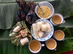a plate of food with bowls of soup and some food at Panguana Lodge all included in Iquitos
