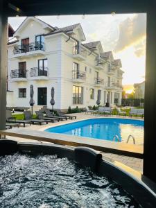 a hotel with a swimming pool in front of a building at Royal Boutique in Râşnov