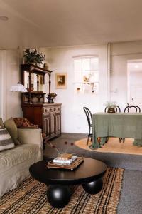 a living room with a couch and a table at Ateliers Den in Beechworth