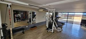a room with a gym with tread machines in it at Quarto triplo em Petrópolis in Natal