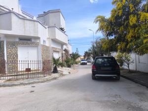 a car parked on a street in front of a house at Bizerte Tunisia cozy studio in Bizerte