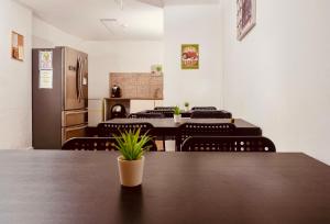 a dining room with tables and chairs and a refrigerator at Guest House Vasco da Gama in Lagos +40 photos