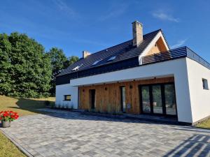 a house with solar panels on the roof at Villa OLIVIA Ferienwohnung Misdroy Insel Ostsee in Wicko