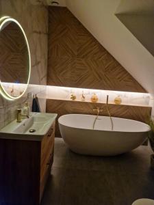 a bathroom with a large tub and a sink at Villa OLIVIA Ferienwohnung Misdroy Insel Ostsee in Wicko +36 photos