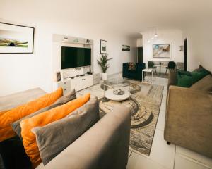 a living room with a couch and a table at AvonHeights Apartments in Lekki Phase 1