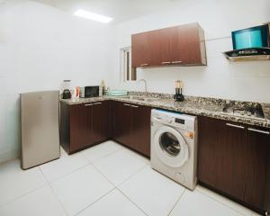 a kitchen with a washer and a washing machine at AvonHeights Apartments in Lekki Phase 1 +1 photo