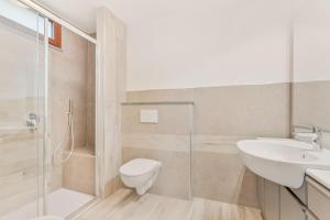 a bathroom with a shower toilet and a sink at La Casetta in Carafà in Aulla