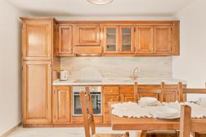 a kitchen with wooden cabinets and a wooden table at La Casetta in Carafà in Aulla +7 photos