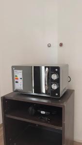 a microwave sitting on top of a wooden table at Rincón del Agreste in Neuquén