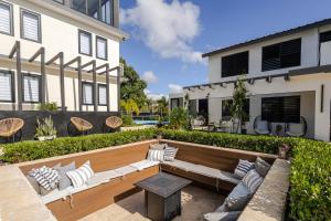 a patio with white furniture in front of a building at 623 Boquerón Villas in Boqueron