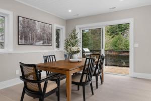 a dining room with a wooden table and chairs at charming riverside retreat in Huntsville