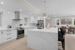 a kitchen with white cabinets and a white counter top at charming riverside retreat in Huntsville