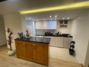 a kitchen with a island in a room at Pyramid View Apartment near GEM in Ghaţāţī