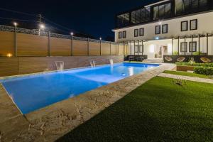 a swimming pool in front of a house at night at 623 Boquerón Villas in Boqueron