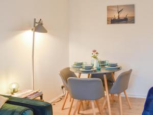 a dining room with a table and chairs at Tankerton Heights in Whitstable