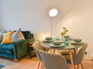 a living room with a table and a couch at Tankerton Heights in Whitstable
