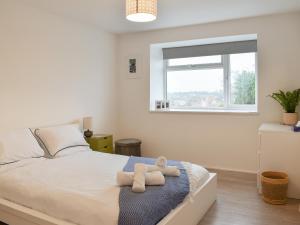 a bedroom with a bed with two towels on it at Tankerton Heights in Whitstable +6 photos
