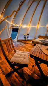 a room with a chair and a table in a tent at glamping podtrosky in Troskovice