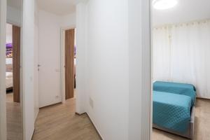 a room with a mirror and a blue chair at Sara Home Flo in Florence +7 photos