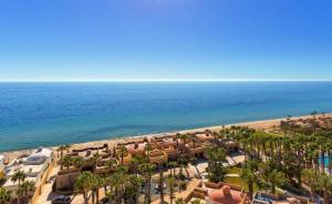 an aerial view of a beach with palm trees and the ocean at Bella Sirena Beachfront Resort Condo D603 in Puerto Peñasco