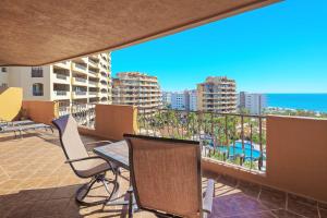 a balcony with a table and chairs and the ocean at Bella Sirena Beachfront Resort Condo D603 in Puerto Peñasco